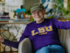 James Carville waiving hello wearing LSU sweatshirt. Movie Winning Is Everything Stupid
